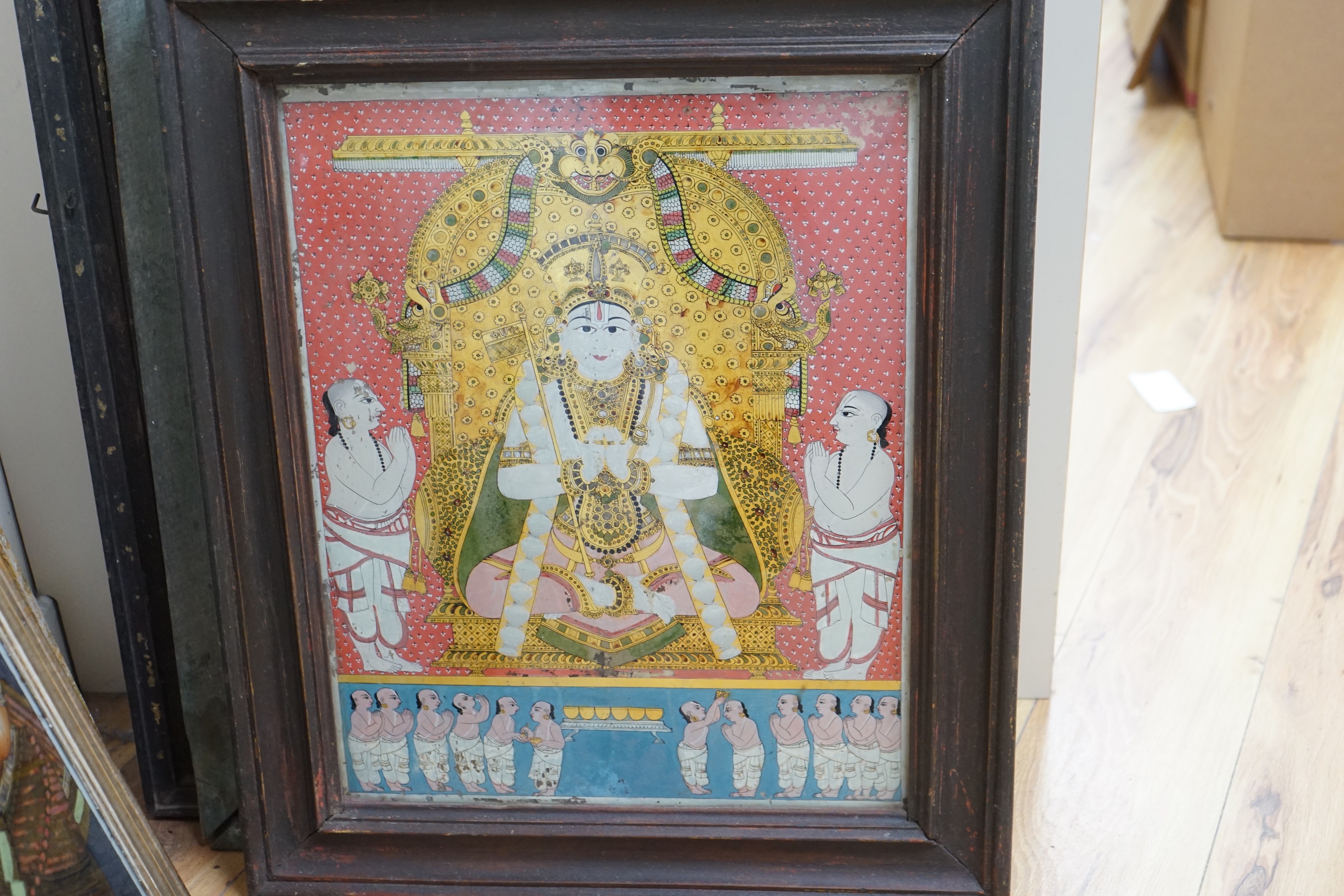 A collection of eight Indian reverse decorated glass pictures, 20th century, largest frame 70cm X 60cm